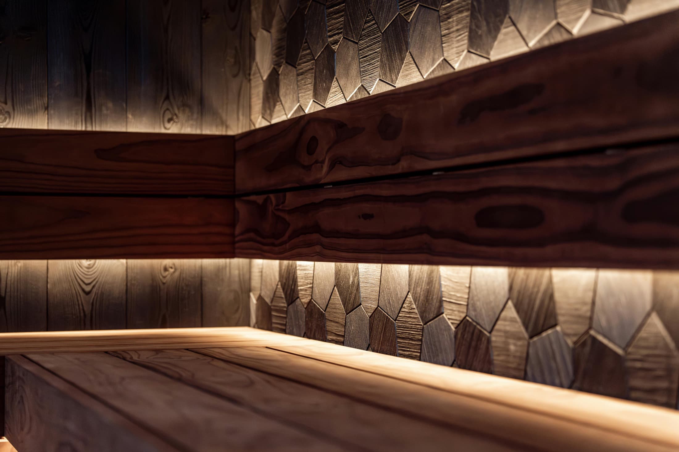 Warm modern infrared sauna interior with wood finishes and ambient lighting.